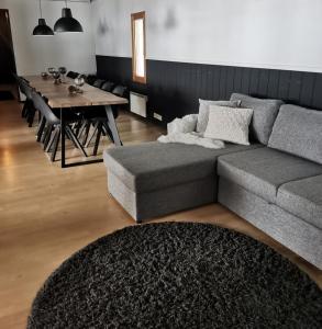 a living room with a couch and a dining table at LakeLodge Kiehinen & Igloos in Rovaniemi