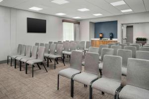 a room with rows of chairs and a screen at Homewood Suites By Hilton Greenville, NC in Greenville