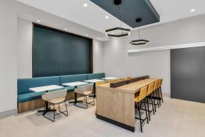 a classroom with tables and chairs and a chalkboard at La Quinta Inn & Suites by Wyndham San Jose Silicon Valley in San Jose