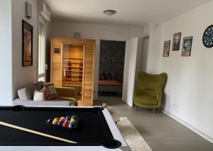 a living room with a pool table in the middle at House Spa Privatif - Jaccuzi et Sauna in Livry-Gargan