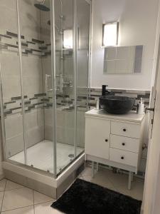 a bathroom with a shower and a sink at House Spa Privatif - Jaccuzi et Sauna in Livry-Gargan