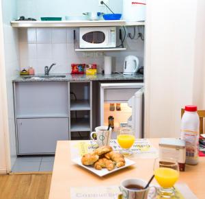 a kitchen with a table with a plate of pastries at Callao Suites Recoleta in Buenos Aires