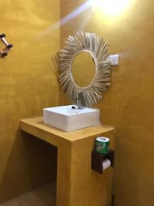 a bathroom with a mirror and a white sink at Mohammed Bungalows and Restaurant in Matemwe