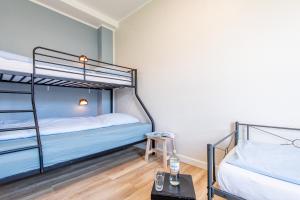 a bedroom with two bunk beds and a table at Steger-Hüs Wohnung 16 in Rantum