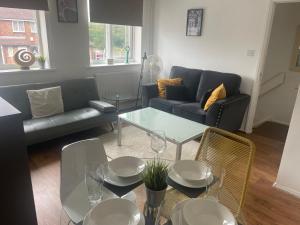 a living room with a couch and a table and chairs at FilmonHomes in Oldbury