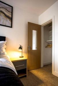 1 dormitorio con 1 cama y escritorio con lámpara en Cosy Cruise Cribs Ltd en Stoke on Trent
