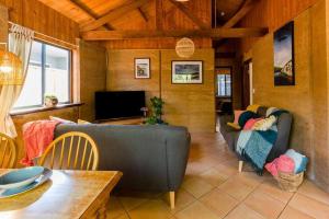 a living room with a couch and a tv at Sea Escape Studio - Beach Hideaway in Prevelly in Prevelly