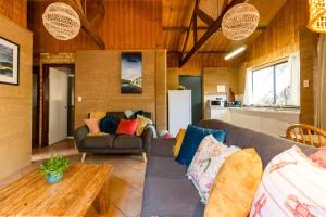 a living room with a couch and a table at Sea Escape Studio - Beach Hideaway in Prevelly in Prevelly