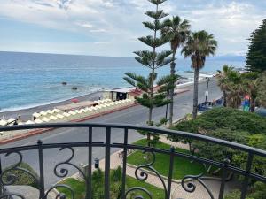 a balcony with a view of a beach and the ocean at Hotel Parigi & Spa in Bordighera