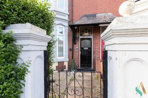 a house with a black door and a fence at 5 Double Bedrooms with Ensuites - Teesside House TSAC in Redcar