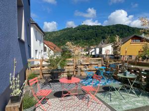 a patio with tables and chairs and a table at Olivia in Tholey