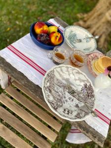 a table with plates and a bowl of fruit on it at La Locanda Del Tevere in Fiano Romano +66 photos