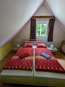 a bedroom with two beds in a attic at Rekreační dům KRKONOŠE - Ubytování - Holidayhome Lampertice in Lampertice