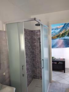 a shower with a glass door in a bathroom at CasarinoLaurino Valle Del Golfo Healthy Air Above The Sea in Uscio