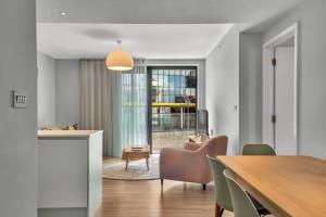 a kitchen and dining room with a table and chairs at Spacious Two Bedroom Apartment at Wembley Park in London