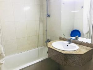 a bathroom with a sink and a bath tub at Apartment in Dubai