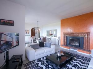 a living room with a white couch and a fireplace at Villa Lakecomo - Ritrovo in Menaggio