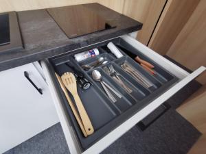 a drawer in a counter with utensils in it at Matteo Aparts in Szklarska Poręba