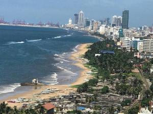 a view of a beach with a city at Blue Ocean in Dehiwala