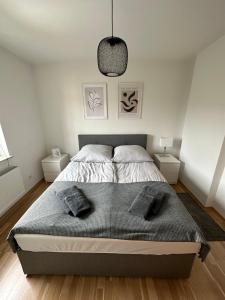 a bedroom with a bed with two pillows on it at Schöne Wohnung im Herzen von Köln Ehrenfeld in Cologne