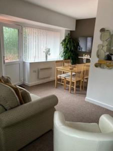 a living room with a couch and a table at Private Annex with Two Bedrooms in Upton