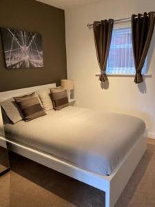 a large bed in a bedroom with a window at Private Annex with Two Bedrooms in Upton