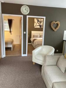 a room with a bedroom with a bed and a mirror at Private Annex with Two Bedrooms in Upton