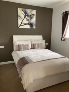 a bedroom with a large bed with two pillows at Private Annex with Two Bedrooms in Upton