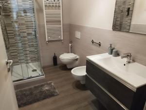 a bathroom with a toilet and a sink and a shower at Casa Vacanze Spolina Cossato BI in Cossato
