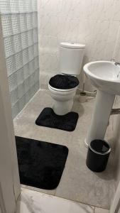 a bathroom with a toilet and a sink at Newly built house in Accra in Danfa