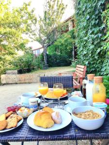 una mesa con platos de comida y vasos de zumo de naranja en Casa de Sao Miguel Douro en Armamar