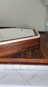 a bed sitting on top of a wooden floor at Apart Hotel 48 in Mogi das Cruzes +12 photos