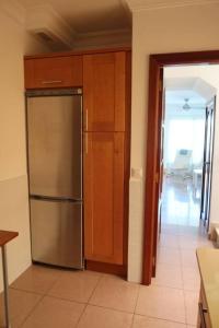 a kitchen with a stainless steel refrigerator in a room at Brisas de Puerto Rico in Puerto Rico de Gran Canaria