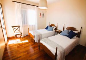a room with two beds and a chair in it at Casa Bahia de Naos con vistas al mar in Arrecife