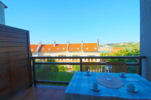 a table with a blue table cloth on a balcony at El Rincón del Mar in San Vicente de la Barquera