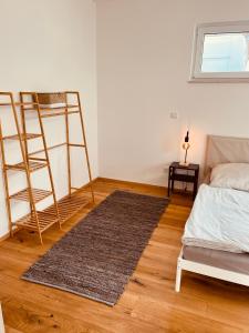 a bedroom with a bed and a ladder and a rug at Romantisches wohnen in Worms