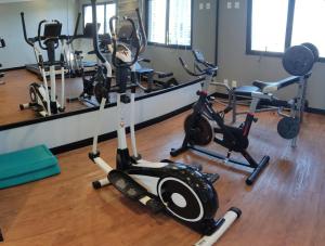 a gym with two exercise bikes and a mirror at Apart Hotel 48 in Mogi das Cruzes