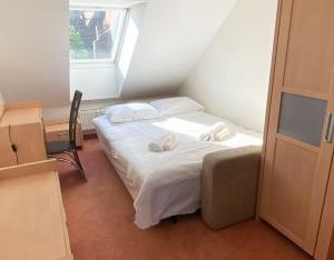 a bedroom with a bed with two towels on it at APARTMENT IN THE HEART OF GDAŃSK in Gdańsk