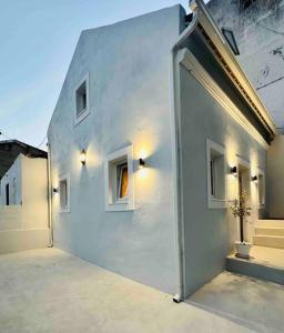 a white building with a door and two windows at New Amaizing Cozy House in the heart Lisbon in Lisbon