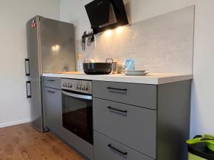 a kitchen with a stove and a refrigerator at Wohnen im idyllischen Schlosshof in Franken in Ebern