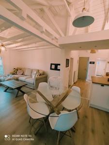 a living room with a table and chairs and a couch at Plane Tree House in Próti