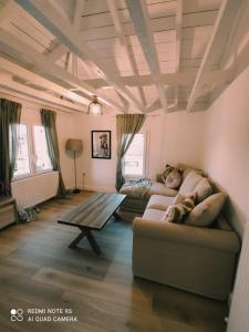 a living room with two couches and a wooden table at Plane Tree House in Próti