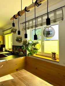 a kitchen with several glass lights hanging from the ceiling at Traumferienhaus Leimbach am Nürburgring in Leimbach