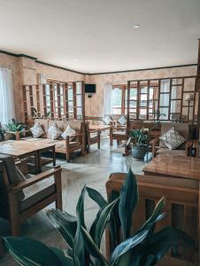 a living room with wooden tables and benches at Hotel Amodhara in Thimphu