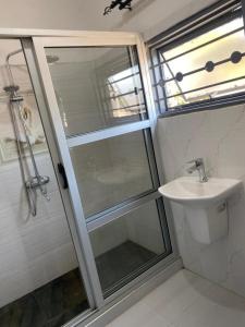 a bathroom with a shower and a sink at Swiss Luxury Apartments in Ndola