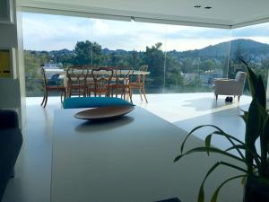 a living room with a table and chairs and a large window at luxury ph private pool+roof garden in Athens