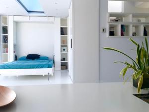 een slaapkamer met een blauw bed en een plant bij luxury ph private pool+roof garden in Athene
