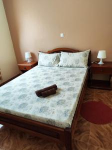 a bed with a brown teddy bear laying on it at Casa Andrade Delgado - Rotxa Grande in Ponta do Sol