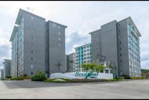 two tall buildings with a sign in front of them at Jay's Condo - Seawind in Davao City