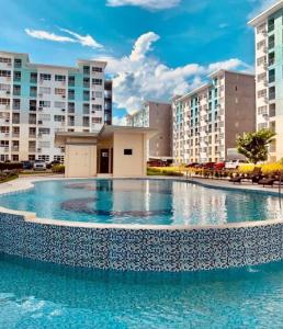 a large swimming pool in the middle of a building at Jay's Condo - Seawind in Davao City